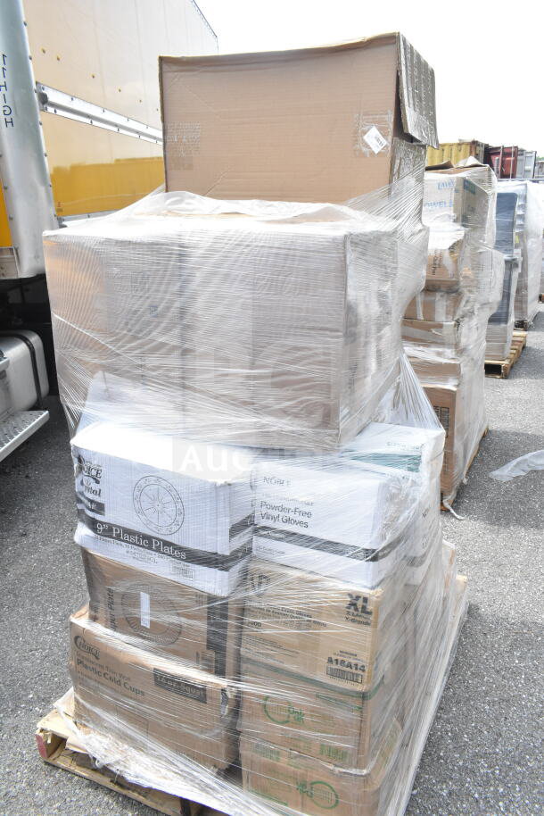 Pallet of 26 scratch and dent items including napkins, 9" plastic plates, vinyl gloves, lids, and cold cups, wrapped in plastic.