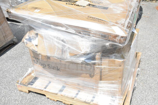 Shrink-wrapped pallet of brand new scratch and dent items including a wire shelf and mop sink, in original packaging.