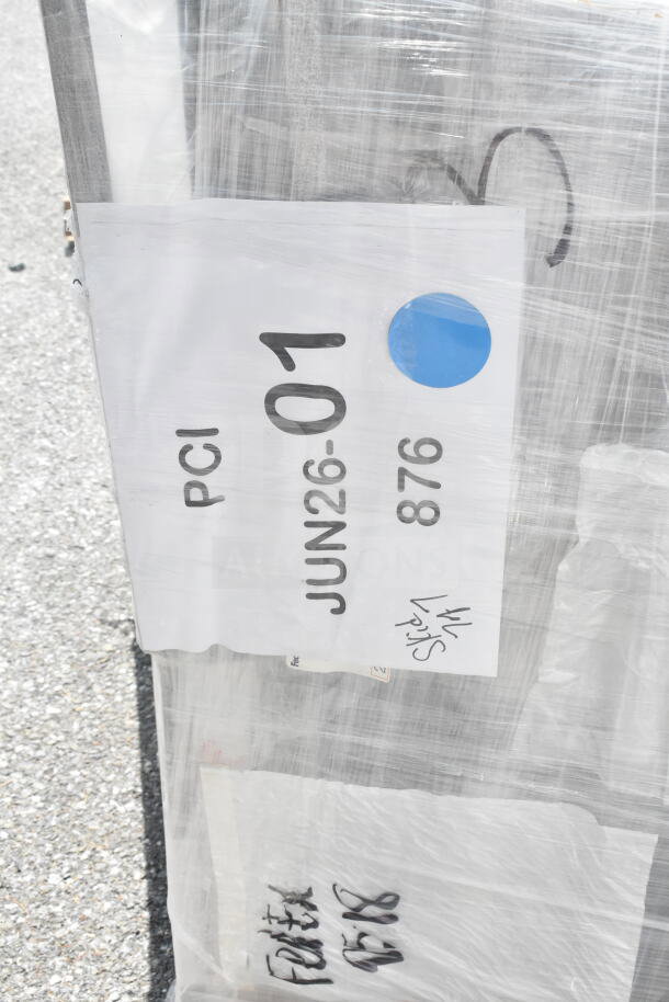 Wrapped package with label reading "PCI JUN26-01 876." Contains 20 new scratch and dent banquet chairs.