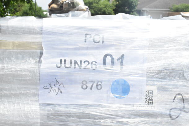 Pallet wrapped in plastic with visible label: "JUN26-01, 876", indicates scratch and dent auction items.