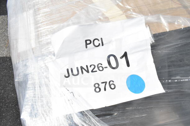 Plastic-wrapped pallet with a visible label reading "JUN26-01, 876, PCI," indicating auction lot details.