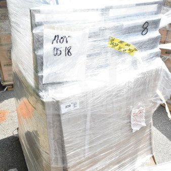 Pallet of 20 new scratch and dent Lancaster banquet chairs wrapped in plastic, with visible labels for auction lot JUN26-01.