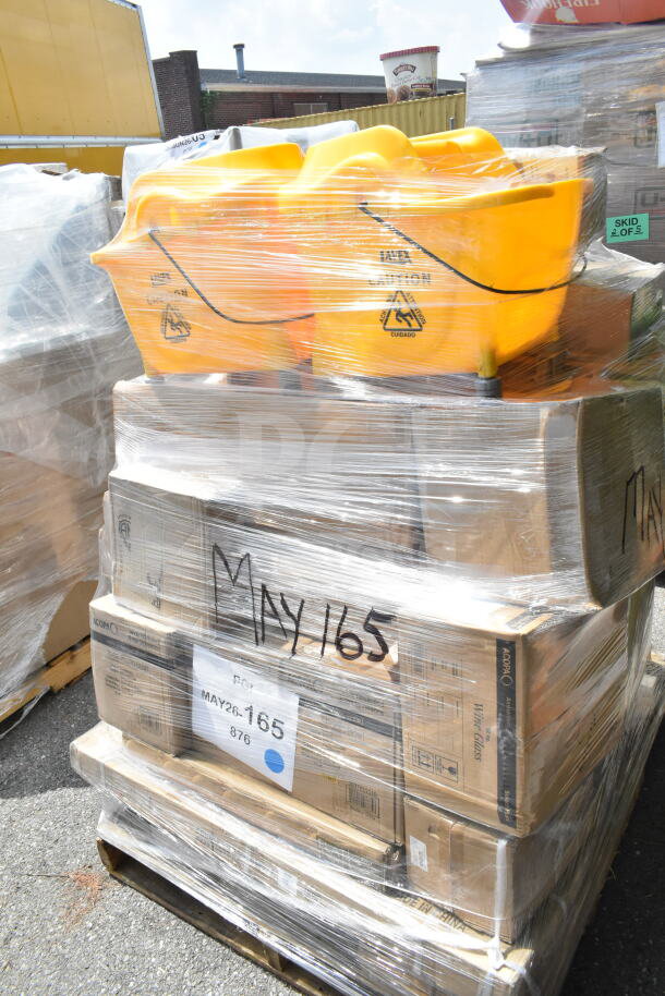 Pallet with 24 scratch and dent items, including yellow mop buckets, speed rails, and pizza pans. Marked MAY26-165.