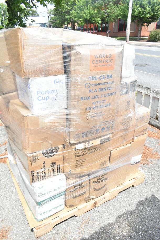 Pallet of 26 boxed scratch and dent items, including napkins, forks, cups, and food trays, wrapped and labeled.