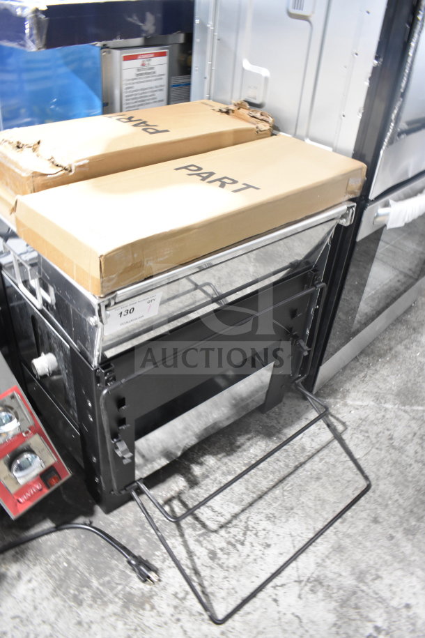 Backyard Pro Grill in new condition, includes original packaging, parts boxed. Sturdy frame, plug visible, labeled with item number 130.