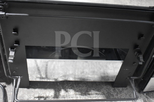 Backyard Pro Grill, black metal exterior, sturdy build, adjustable vents, suitable for outdoor cooking, good condition.