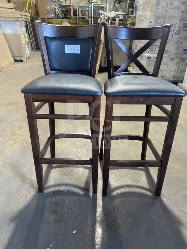 Two brand new commercial bar stools with mahogany finish, cushion back, and black vinyl seats. Tag shows bid multiplier.