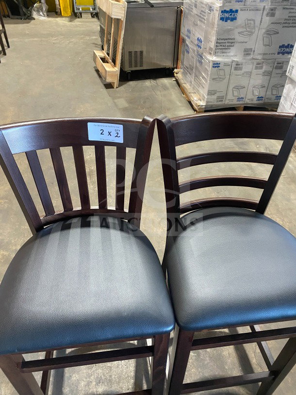 Brand new mahogany finish wood bar stools with cushion back and black vinyl seats. Includes 2 stools in excellent condition.