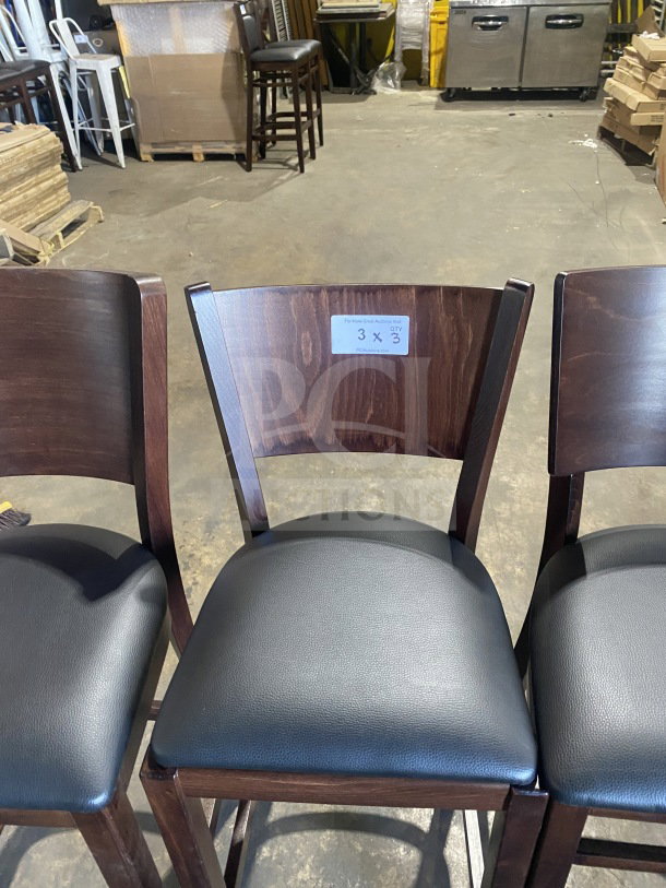 Brand new mahogany finish wood bar stool with cushion back and black vinyl seat. Includes "3X" tag for auction.