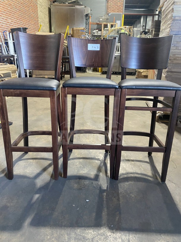 Brand new mahogany finish bar stools with cushioned black vinyl seats. Commercial quality. Set of three.