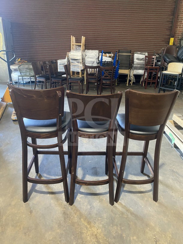 Brand new commercial mahogany finish wood bar stools, black vinyl seats, cushioned backs, set of three.