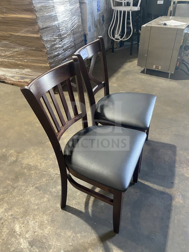 Brand new mahogany wood dining chairs with black vinyl seats, table-height, commercial quality, auction tag "141".