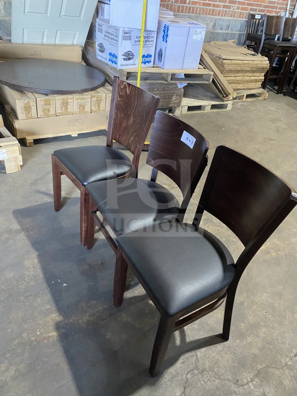 Brand new commercial mahogany dining chairs, wood finish, black vinyl seats. Set of three. Auction item.