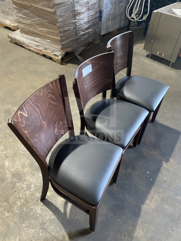 Brand new commercial mahogany finish dining chairs with black vinyl seats, shown in a set of three.