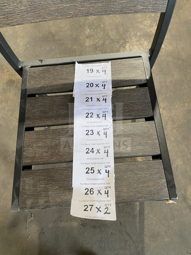Brand new commercial outdoor teak chair with gray slats. Features durable construction, modern design. Includes auction info tags.
