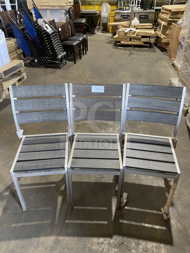 Brand new commercial outdoor teak chairs with gray slats, metal frame. Set of three, labeled "37 x 3".