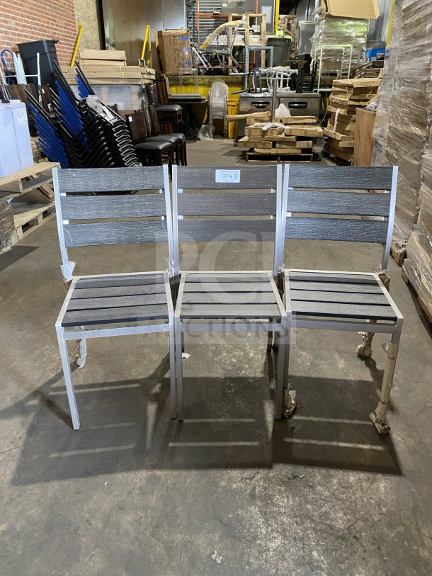Brand new commercial outdoor teak chair set with gray slats, metal frame, protective packaging, tag marked "37 x 3."