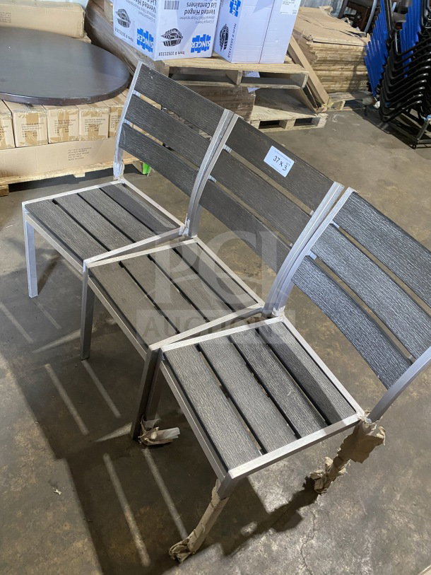 Brand new commercial outdoor teak chairs with gray slats, unwrapped. Durable, modern design. Tags read "3X Your Bid!"