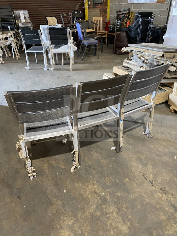 Brand new commercial outdoor teak chair with gray slats, still wrapped, in pristine condition.