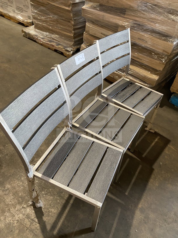 Brand new commercial outdoor teak chair with gray slats, pristine condition. Tag shows "37x5."
