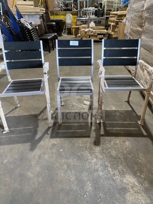 Brand new commercial outdoor teak chair with black slats; features durable construction and sleek design; set of three.