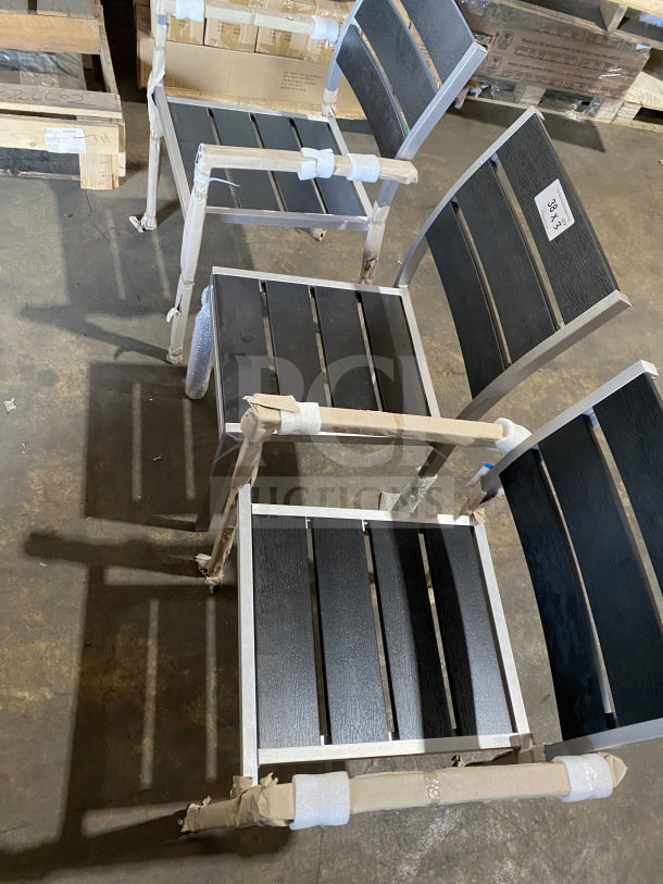 Brand new commercial outdoor teak chair with black slats, wrapped for protection. High durability, ideal for outdoor use.
