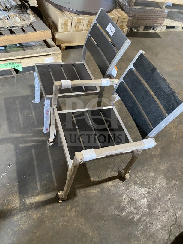 Brand new commercial outdoor teak chair with black slats, protective wrapping, item tag visible, pristine condition.