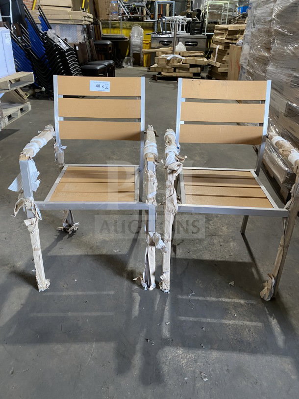 Brand new commercial aluminum arm chairs with tan synthetic teak slats, stackable design. Auction offers two chairs per bid.
