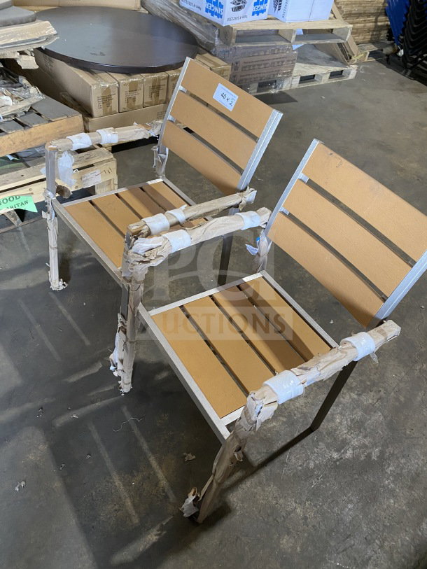 Brand new commercial aluminum outdoor arm chairs with tan synthetic teak slats, stackable, protective packaging included.