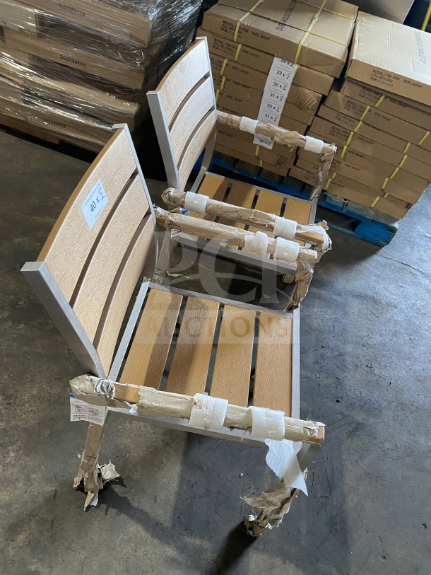 Brand new commercial aluminum outdoor stackable arm chair with tan synthetic teak slats, partially packaged.