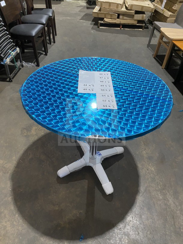 Brand new commercial stainless steel cocktail table, model D36, with polished base and blue-wrapped plate top.