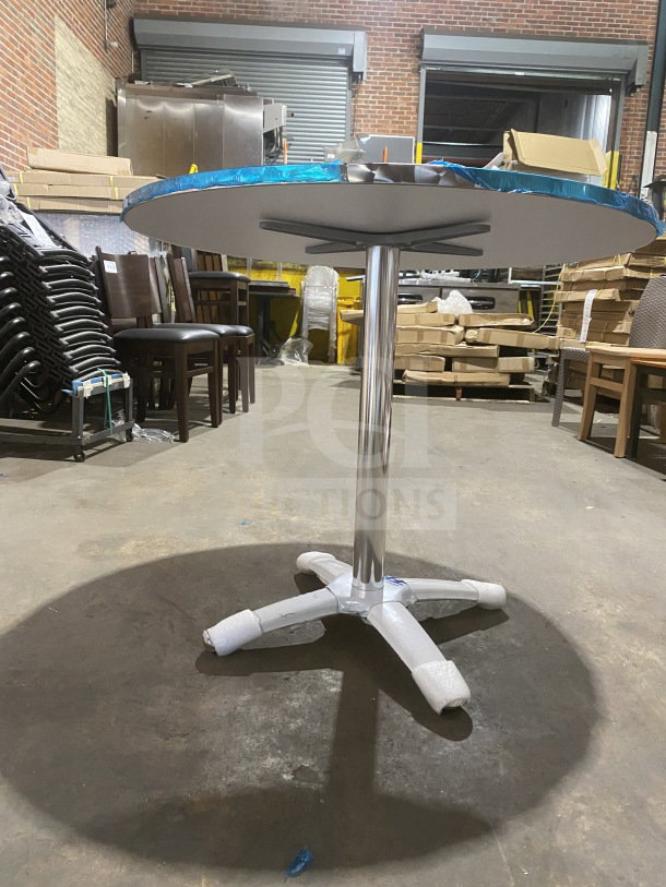 Brand new stainless steel cocktail table, Model D36, with polished base, wrapped top, in excellent condition.