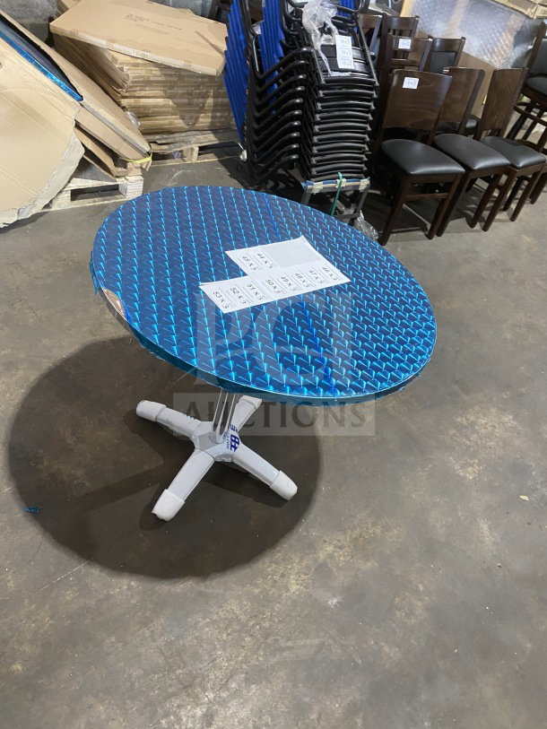 Brand new commercial stainless steel table, model D36, with polished base. Wrapped blue top, ideal for dining or cocktails.