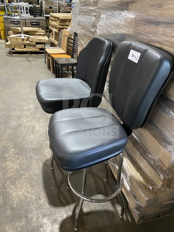 Commercial chrome frame swivel bar stool with black vinyl bucket seat, brand new, warehouse setting, labeled "54 x 12."