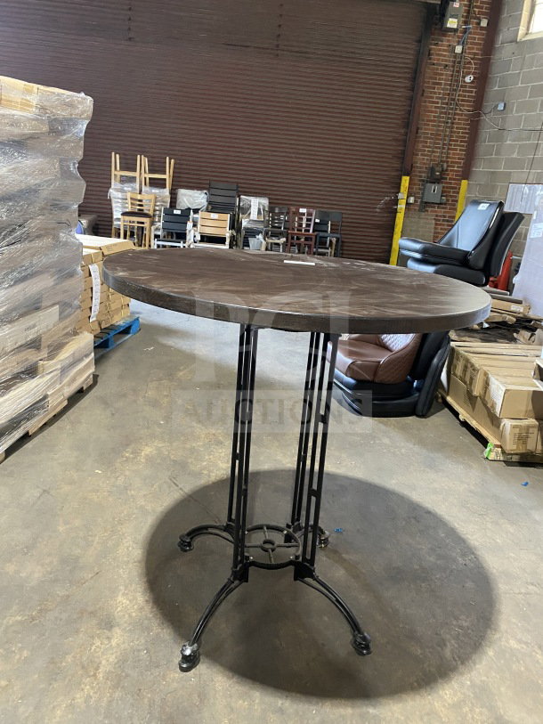 Brand new 42" round composite bar-height table for indoor/outdoor use, featuring a metal base in a commercial setting.