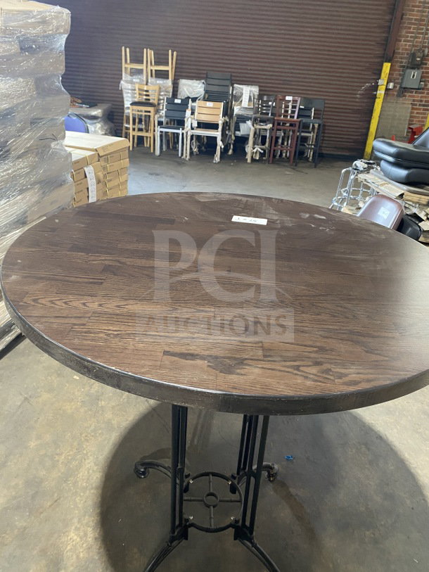 Brand new 42" round composite bar-height table, suitable for indoor/outdoor use. Dark wood finish, metal base.