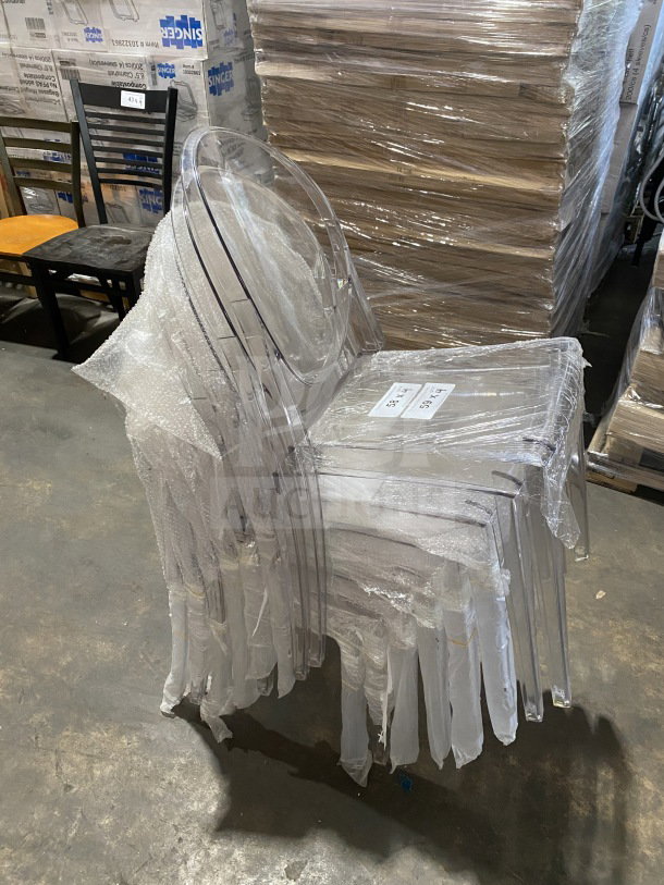 Brand new GA Commercial Ghost transparent polycarbonate stackable side chair with oval back, wrapped in protective covering.