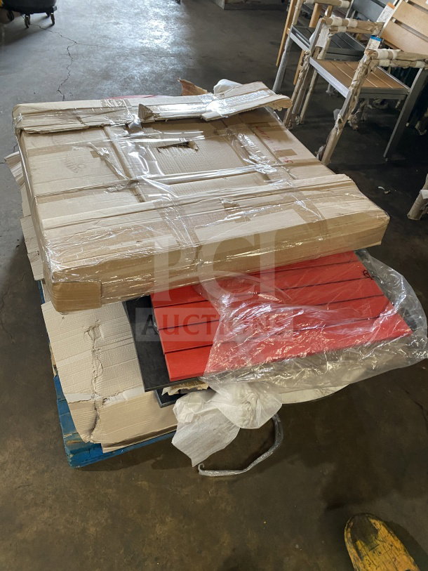 Brand new commercial restaurant and cafe table tops in packaging, featuring bright red and black surfaces, ready for assembly.