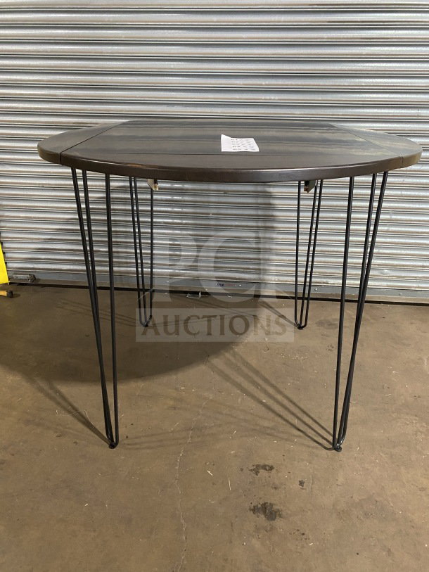 Brand new 42" round composite bar height table with hairpin legs, suitable for indoor/outdoor use.