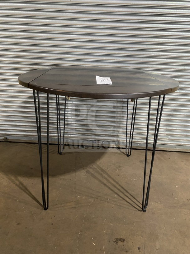 Brand new 42" round composite bar height table with hairpin legs, suitable for indoor/outdoor use.