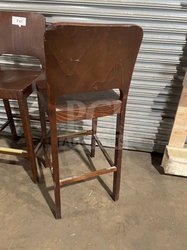 Commercial modern wooden bar height stools, new condition, dark finish, minimal wear, visible "2X Your Bid" tag.