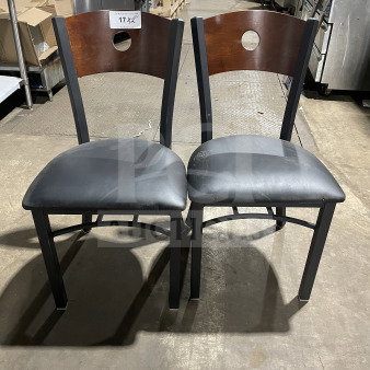 Brand new metal dining chairs with cherry wood cutout backs, black vinyl seats. Perfect condition, great for commercial use.