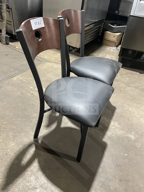 Brand new commercial dining chair; cherry wood cutout back, black vinyl seat. High-quality metal frame, excellent condition.