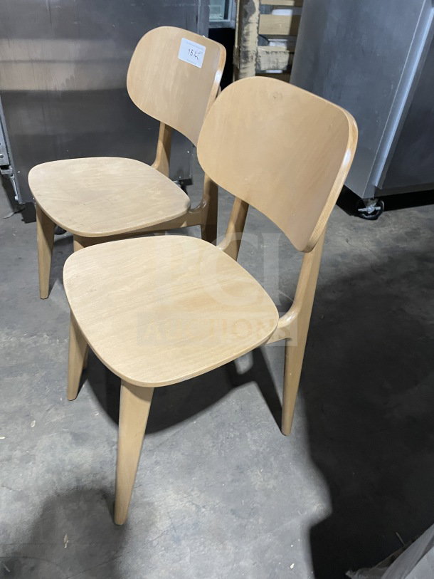 New commercial wood Emma dining chair in natural finish, upholstered seat, excellent condition, with visible price tag.