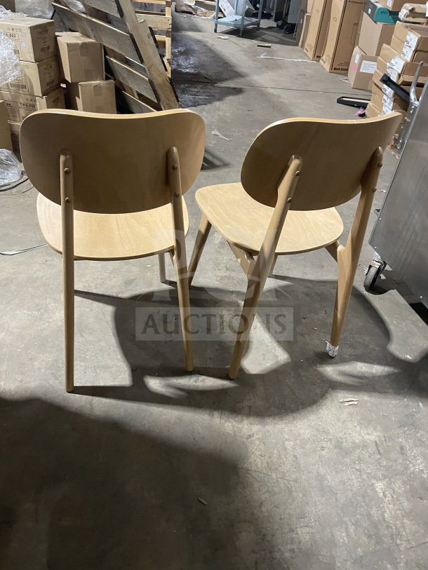 "New commercial wood dining chairs with natural finish, upholstered seat. Emma model, indoor use. Sold in pairs."
