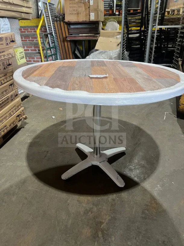 BRAND NEW OCS 24" round barn wood plank composite dining table with polished base. Industrial setting.