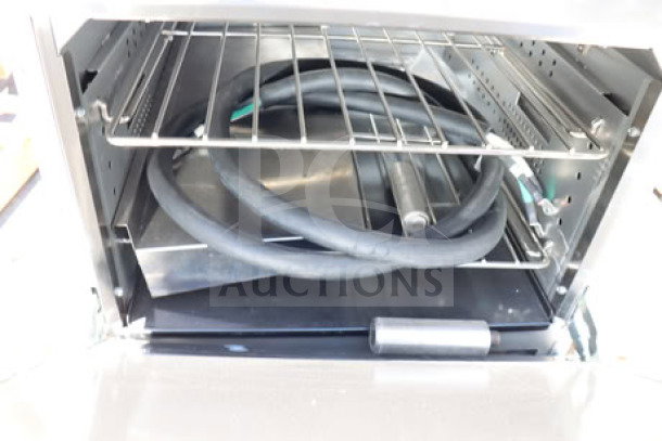 Brand new Cooking Performance Group ER24-240-1 24" 4-burner electric range, visible oven interior, serial #2411039025.