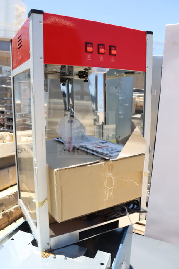 Carnival King PM1360 12 oz. commercial popcorn machine, brand new with minor dents. Red top, 120V, 1360W, packaging inside.