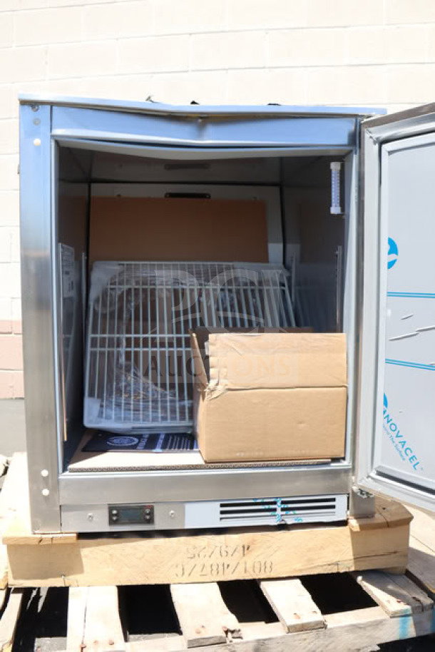 BRAND NEW SCRATCH-N-DENT Beverage-Air UCF24AHC 24" undercounter freezer, open door showing interior racks, on wooden pallet.