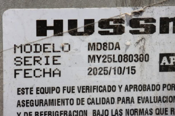 Hussmann MD8DA8 label showing model, serial number MY25L080300, and inspection date, relevant for auction verification.